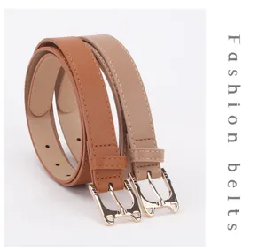 Detailed view of caramel and beige thin belts with gold cat-shaped metal buckles