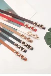 Collection of seven slim PU leather belts with gold metal chain buckles for women