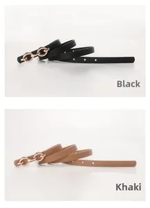 Close-up of thin faux leather belts in black and khaki with gold chain metal buckles
