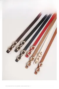 Detailed view of various colorful PU leather belts with decorative gold metal buckles