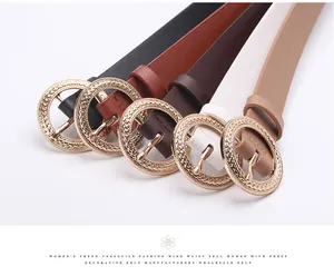 Detail of five multi-colored waist belts with textured golden round buckles for women