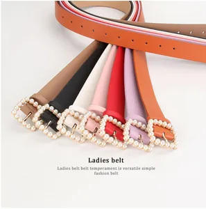 Showcase of colorful leather belts for women with square pearl-encrusted metal buckles