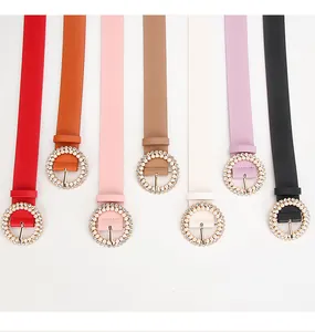 Detail of elegant thin PU leather belts with decorative pearl-encrusted metal buckles