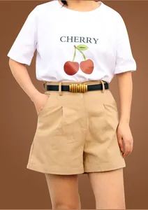 Detail of a thin black PU leather belt with a golden multi-joint buckle on khaki shorts