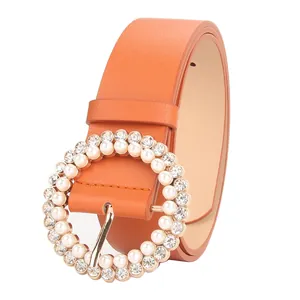 Elegant orange PU leather belt for women featuring a pearl and rhinestone circular buckle