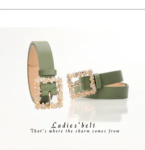 Close-up of a ladies' light green PU leather belt with a golden rhinestone square buckle