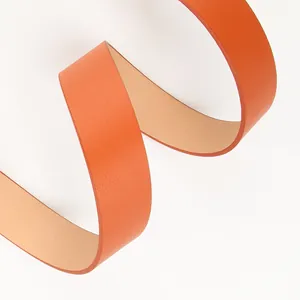 Elegant bright orange leather belt for women featuring a minimalist coiled texture design
