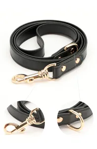 Detailed view of black PU leather pet leash with gold-tone metal swivel hook and rivets