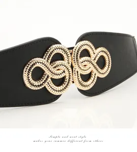 Close-up of a wide elastic waist belt with a textured gold infinity interlocking buckle
