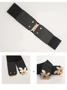 Detail of wide elastic belt featuring a golden metallic hollow leaf buckle and black strap