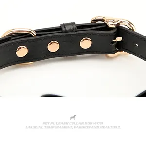 Detail of black PU leather pet collar with gold metal rivets and stitching