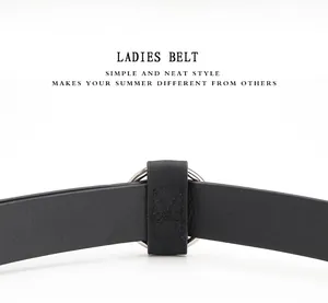 Close-up of a minimalist black PU leather belt with a round silver metal buckle