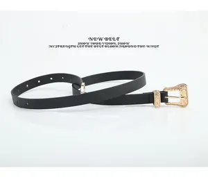 Detail of black leather belt with ornate vintage gold metal buckle and texture