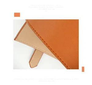 Detailed macro view of an orange classic waistband showing premium leather texture and stitching