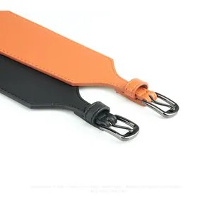 Detail of premium leather waist belts in black and orange with metal pin buckles