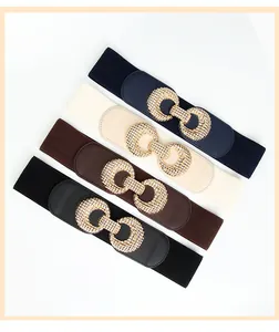 Detail showing elastic wide belts in four colors with textured gold interlocking buckles