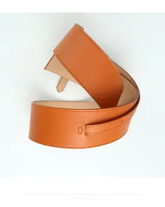 Detail view of a vintage tan leather corset belt with elegant decorative stitching