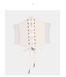 Close-up of white corset belt featuring front lace-up design and elastic side panels