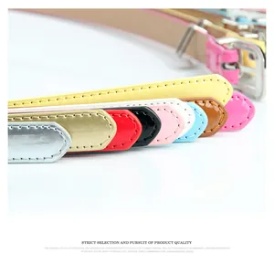 Detailed view of colorful glossy leather belts with premium stitching and silver metal buckles