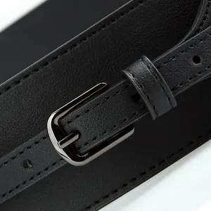 Minimalist wide black leather waist belt with sleek metal buckle for coats and dresses