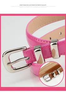 Macro detail of glossy pink and brown skinny belts with silver metal buckle and stitching