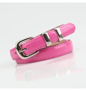 Close-up of glossy magenta faux leather belt with polished silver buckle and loops