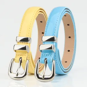 Slim patent leather belts for women in pale yellow and light blue with silver buckles