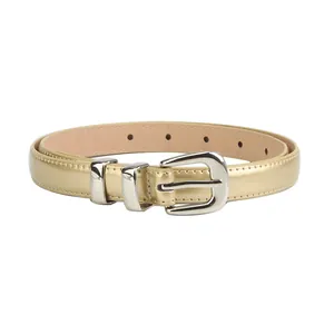 Women's slim gold leather belt with silver pin buckle for jeans on white background