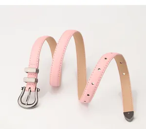 Detail of pink faux leather belt with silver horseshoe buckle and fine stitching