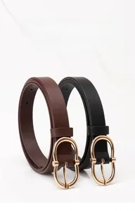 Detail view of black and dark brown leather belts with elegant golden oval buckles