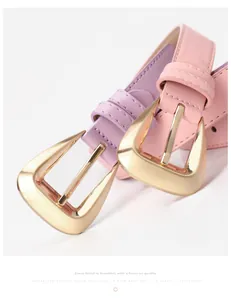 Macro detail of pink and lilac leather belts with golden geometric brushed metal buckles