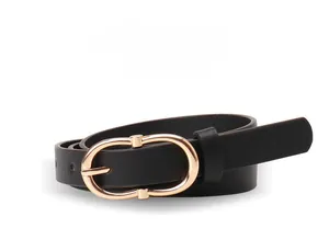 Close-up of slim black leather belt with a polished gold oval buckle and metal loop