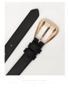 Close-up of black PU leather belt with gold metal buckle and precision stitching detail