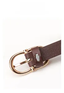 Detail of dark brown leather belt with polished gold horseshoe buckle and smooth texture