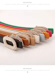 Detail of slim faux leather belts with pearl and rhinestone encrusted oval buckles