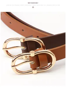 Close-up of slim leather belts with gold oval buckles in dark brown and caramel