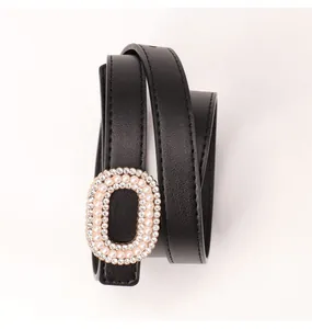 Black leather belt with oval buckle featuring pearls and rhinestones in coiled view