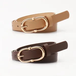 Minimalist women's leather belts in camel and dark brown with oval gold buckles