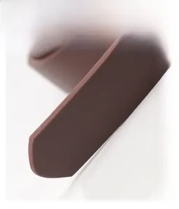 Macro detail of smooth hand-polished edges on a brown matte leather belt with lychee texture