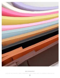 Detail shot of slim PU leather belts in multiple candy colors for women's jeans