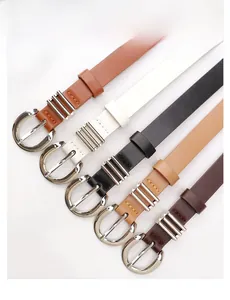 Detail of five slim faux leather belts with silver round buckles and adjustable holes