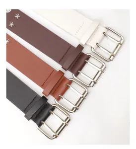 Detailed view of four colorful punk belts with silver buckles and star rivet accents