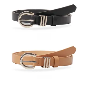 Close-up of black and khaki slim belts with silver horseshoe buckles and metallic loops
