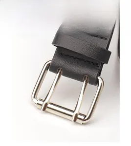 Close-up of black lychee grain leather belt with silver double-prong metal buckle