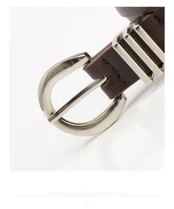 Close-up of a dark brown leather belt featuring a polished silver metal pin buckle