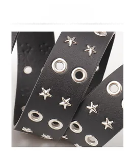 Close-up of matte black leather belt with silver star rivets and metal eyelet details