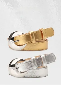 Detail of trendy metallic crescent buckle on high-quality silver textured leather belt