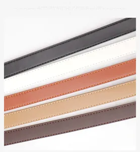 Détail de ceintures étroites en similicuir noir, blanc et marron avec surpiqûres fines