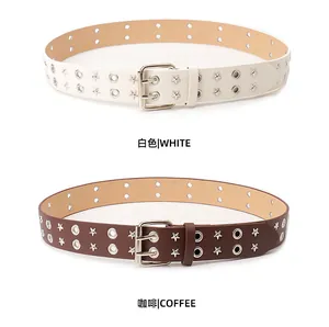 Detail of white and brown punk belts with star studs and double row eyelets