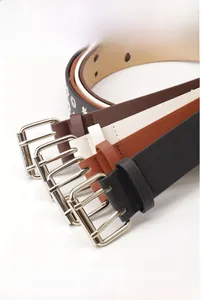 Detail view of punk style leather belts with silver double prong buckles and eyelets